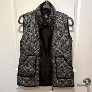 Black and white patterned vest with gold zipper